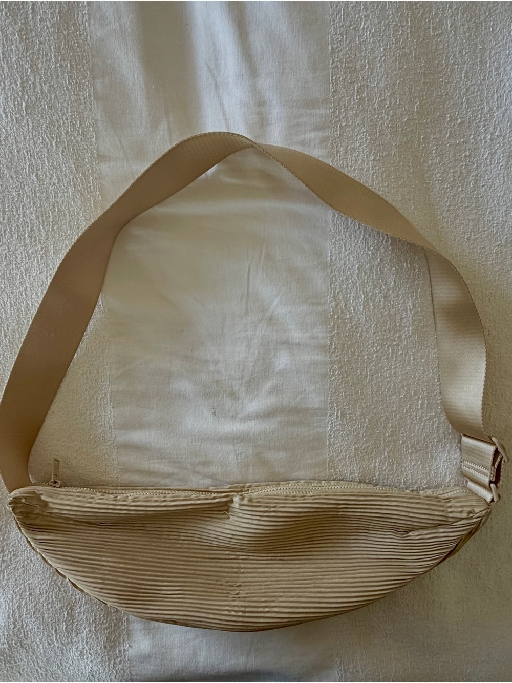 COS pleated crossbody bag in cream/tan.